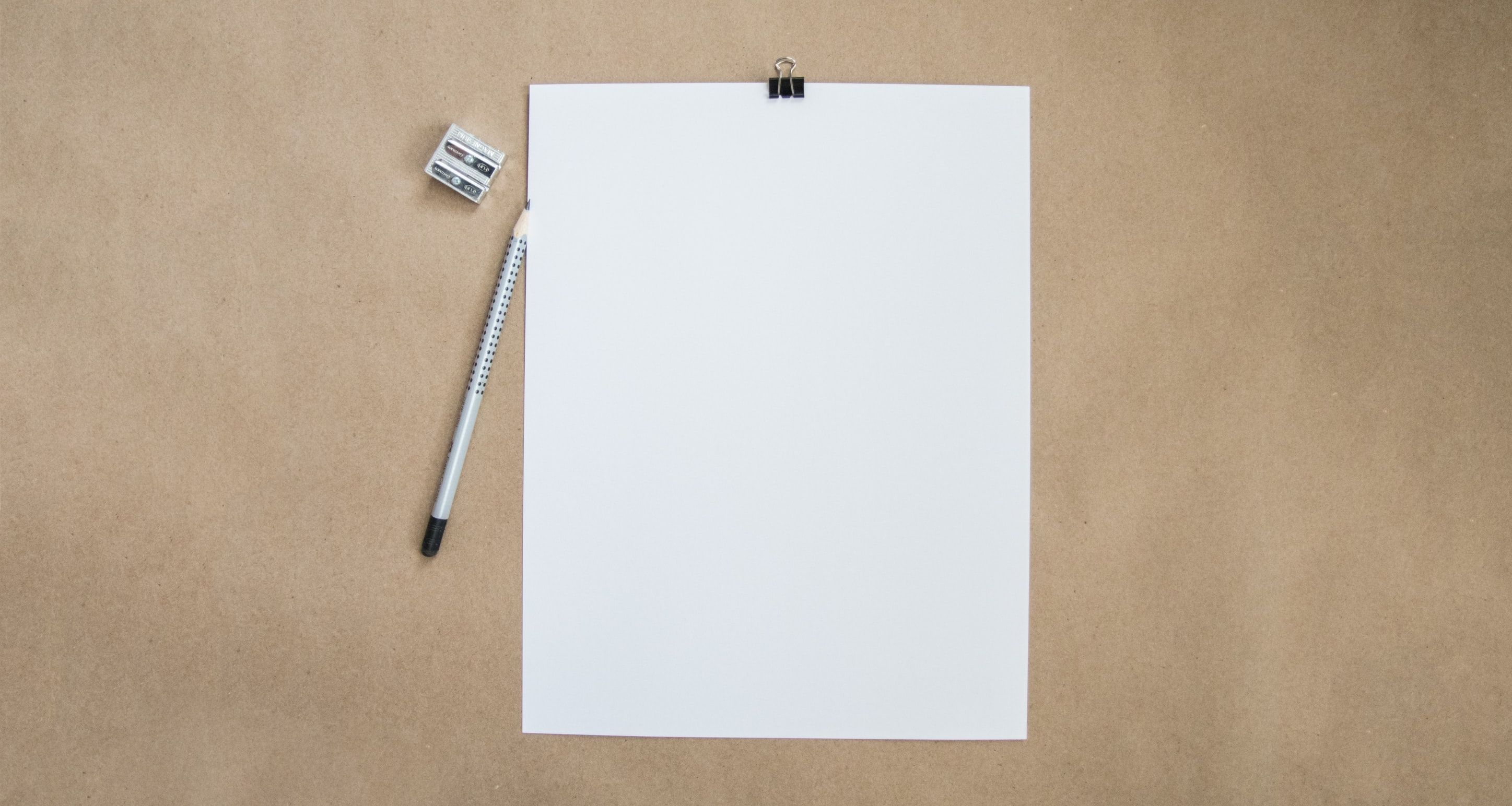 paper, pencil, and sharpener on desk